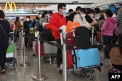 Passengers queue to check-in at the international airport in Hong Kong on Dec. 28, 2022.