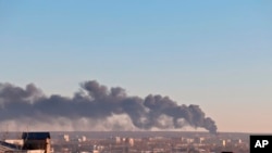 In this handout photo released by the administration of the Kursk region of Russia on Tuesday, Dec. 6, 2022, smoke rises from the area of Kursk airport outside Kursk, Russia. A fire that broke out at an airport in Russia’s southern Kursk region that borders Ukraine was the result of a drone attack, the Kursk regional governor said Tuesday, a day after Moscow blamed Kyiv for drone strikes on two air bases deep inside Russia and launched a new wave of missile strikes on Ukrainian territory. (Administration of the Kursk region of Russia via AP)