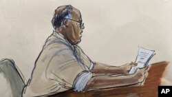 In this courtroom sketch, Frank James, reads a statement of guilt relating to a subway shooting, in Brooklyn federal court, Jan. 3, 2023, in New York.