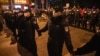 Chinese policemen form a line to stop protesters marching in Beijing, Nov. 27, 2022. 