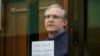 FILE - Paul Whelan, a former U.S. marine who was arrested for alleged spying, listens to the verdict in a courtroom at the Moscow City Court in Moscow, Russia, June 15, 2020. 