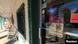 FILE - A "We're Hiring!" sign advertises job openings at a bakery in Old Chelsea village, Quebec, Canada, Oct. 3, 2022. Canada’s eagerness for new immigrants is partly driven by an acute labor shortage attributed in part to a rapidly aging population.