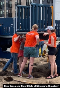 Employees of Blue Cross and Blue Shield of Minnesota build a playground at a YMCA in Minneapolis. (Photo courtesy of Blue Cross and Blue Shield of Minnesota)