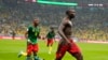 Cameroon's Vincent Aboubakar, right, celebrates with teammates after scoring the opening goal during the World Cup group G soccer match between Cameroon and Brazil, at the Lusail Stadium in Lusail, Qatar, Friday, Dec. 2, 2022.