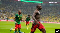 Cameroon's Vincent Aboubakar, right, celebrates with teammates after scoring the opening goal during the World Cup group G soccer match between Cameroon and Brazil, at the Lusail Stadium in Lusail, Qatar, Friday, Dec. 2, 2022.