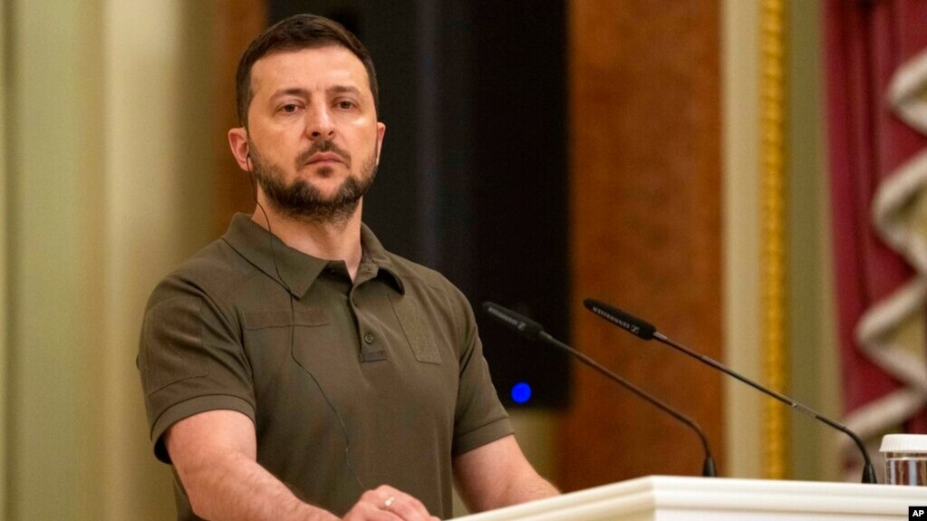 FILE - Ukrainian President Volodymyr Zelenskyy stands at the podium during a news conference in Kyiv, July 3, 2022. 