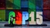 Police officers walk past a sign as they patrol outside the Palais de Congres, during the opening of COP15, a two-week U.N. biodiversity summit in Montreal, Canada, Dec. 6, 2022.