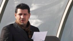 FILE - Former Iran's national soccer team coach Ali Daei before a match in Tehran, Jan. 14, 2009. Daei says his wife and daughter departed from Tehran, legally before the flight made an unannounced stop on Kish Island in the Persian Gulf, where they were questioned.