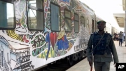 FILE - A police officer walks past a train at the train station in Abuja, Nigeria, Dec. 5, 2022. 