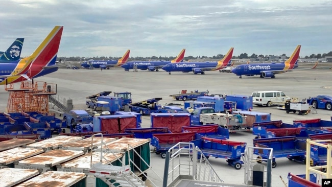 Southwest Airlines jets are seen at the John Wayne Airport in Santa Ana, Calif., Dec. 27, 2022. Southwest Airlines scrubbed thousands of flights Tuesday in the aftermath of the massive winter storm that wrecked Christmas travel plans across the U.S.
