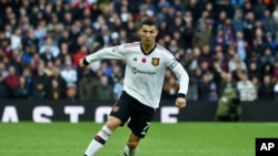 Manchester United's Cristiano Ronaldo runs with the ball during the English Premier League soccer match between Aston Villa and Manchester United at Villa Park in Birmingham, England, Nov. 6, 2022.
