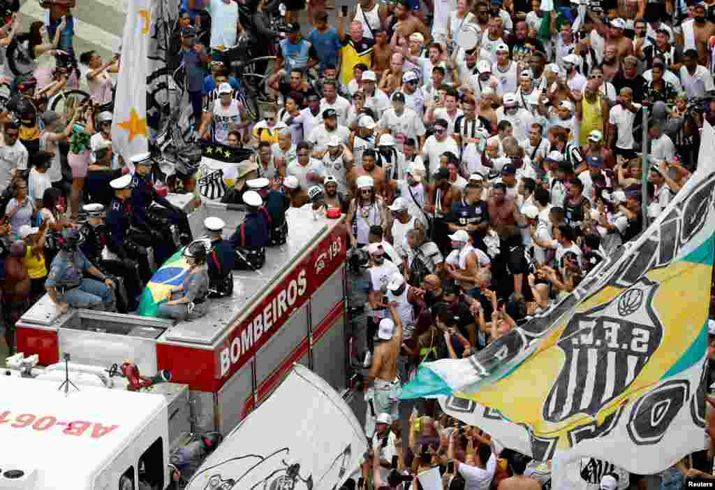 The casket of Brazilian soccer legend Pele is transported to the Santos&#39; Memorial Cemetery during his funeral procession in Santos.