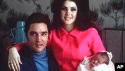 FILE - Elvis Presley poses with wife Priscilla and daughter Lisa Marie, in a room at Baptist hospital in Memphis, Tenn., on Feb. 5, 1968. Presley died Jan. 12, 2023, after a hospitalization, her mother said. She was 54.