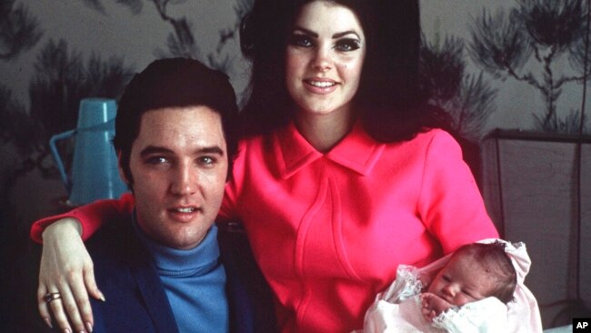 FILE - Elvis Presley poses with wife Priscilla and daughter Lisa Marie, in a room at Baptist hospital in Memphis, Tenn., on Feb. 5, 1968. Presley died Jan. 12, 2023, after a hospitalization, her mother said. She was 54.