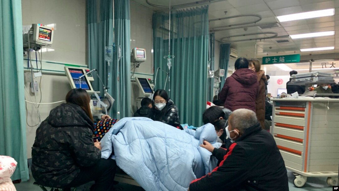 Relatives gather near the bed of a patient at the emergency department of the Langfang No. 4 People's Hospital in Bazhou city in northern China's Hebei province, Dec. 22, 2022. 