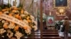 A person pays homage in front of a photo of former Pope Benedict, at the Apostolic Nunciature, or the Vatican's embassy, in Madrid, Spain, Jan. 3, 2023. 