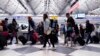 Travelers walk through Terminal 3 at O'Hare International Airport in Chicago, Dec. 22, 2022.