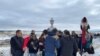 Oglala Lakota president Frank Star Comes Out (L), holding the tribe's canupa (pipe), joins Lakota gathered at Wounded Knee Cemetery to honor massacre victims, Dec. 29, 2022. Courtesy Frank Star Comes Out.