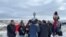 Oglala Lakota president Frank Star Comes Out (L), holding the tribe's canupa (pipe), joins Lakota gathered at Wounded Knee Cemetery to honor massacre victims, Dec. 29, 2022. Courtesy Frank Star Comes Out.