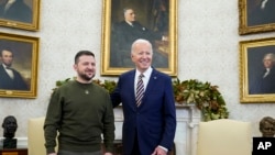 President Joe Biden poses for a photo with Ukrainian President Volodymyr Zelenskyy in the Oval Office of the White House, in Washington, Dec. 21, 2022.