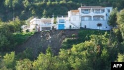 A photo shows houses on the edge of a landslide in Casamicciola on Nov. 27, 2022, following heavy rains on the island of Ischia, southern Italy.