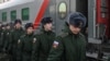 Russian conscripts called up for military service walk along a platform before boarding a train as they the depart for garrisons at a railway station in Omsk, Russia Nov. 27, 2022.