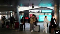 Passengers arriving from China pass by a COVID-19 testing center at the Incheon International Airport In Incheon, South Korea, Jan. 10, 2023. 