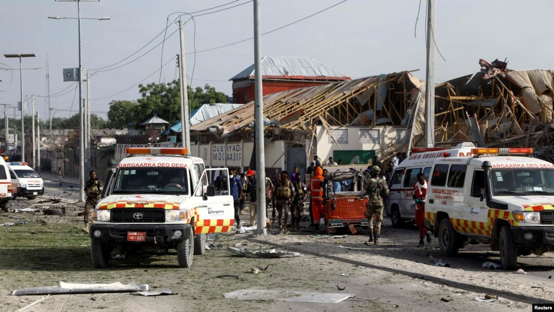 FILE - Somali police and paramedics are seen at the scene after a car exploded in a suicide attack near Mucassar primary and secondary school in Hodan district of Mogadishu, Somalia Nov. 25, 2021.