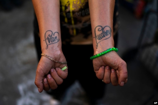 FILE - Jennifer Catano, a 27-year-old fentanyl addict, shows tattoos of the names of her two children, Evan and Audrey, in Los Angeles, Aug. 23, 2022.