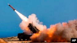 FILE - In this image released by the U.S. Department of Defense, German soldiers assigned to Surface Air and Missile Defense Wing 1, fire the Patriot weapons system at the NATO Missile Firing Installation, in Chania, Greece, on Nov. 8, 2017.