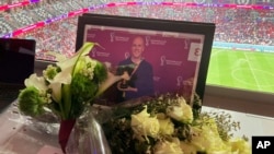 A tribute to journalist Grant Wahl is seen on his previously assigned seat at the World Cup quarterfinal soccer match between England and France, at the Al Bayt Stadium in Al Khor, Qatar, Dec. 10, 2022.