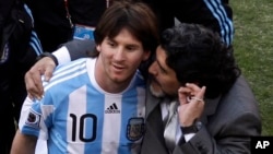 FILE - Argentine soccer legend Diego Maradona, right, coached Lionel Messi in the World Cup in Johannesburg, South Africa, June 17, 2010.