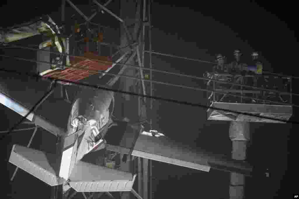 First responders work to rescue aircraft passengers after the small plane crashed and stuck in live power lines in Montgomery Village, a northern suburb of Gaithersburg, Maryland. Both occupants were successfully rescued.