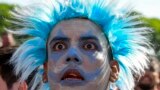 An Argentina soccer fan watches the team lose to Saudi Arabia at a World Cup Group C soccer match, played on a large screen in the Palermo neighborhood of Buenos, Aires, Argentina, Nov. 22, 2022.