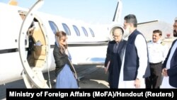 FILE - Pakistan's Minister of State Hina Rabbani Khar, left, greets Ubaid-ur-Rahman Nizamani, head of Mission of Embassy of Pakistan, right, upon her arrival in Kabul, Afghanistan, Nov. 29, 2022. 