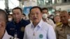 Thai Health Minister Anutin Charnvirakul, center, walks with officials at Suvarnabhumi Airport in Bangkok, Jan. 9, 2023.