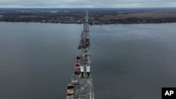 FILE - General view of the damaged Antonivsky Bridge in Kherson, Ukraine, Nov. 27, 2022.