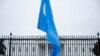 FILE - A Uyghur flag is held high on Pennsylvania Avenue in front of the White House during a protest against the Chinese Communist Party, Oct. 1, 2022.
