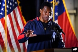 FILE - Republican nominee for US Senate Herschel Walker speaks during a campaign rally, in Canton, Ga., Nov. 10, 2022.