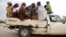 FILE - Women travel in the back of a truck in the town of Mararaba after the Nigerian military recaptured it from Boko Haram, in Adamawa state, May 10, 2015.