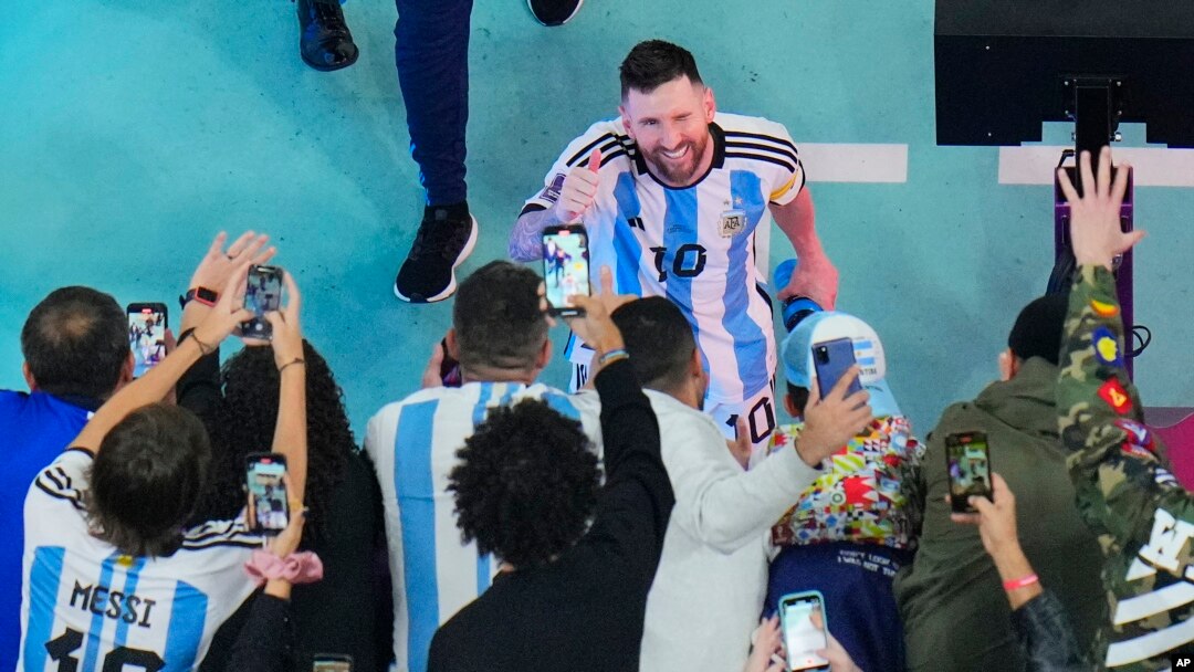 Argentina's Lionel Messi greets cheering fans after his team beat Croatia 3-0 in the World Cup in Lusail, Qatar, Dec. 13, 2022. 