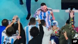 Argentina's Lionel Messi greets cheering fans after his team beat Croatia 3-0 in the World Cup in Lusail, Qatar, Dec. 13, 2022. 