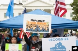FILE - East Turkistan Awakening Movement holds a rally outside the White House against alleged oppression of Uyghurs in far-western Xinjiang province by the Chinese government, to coincide with the 73rd National Day of the People's Republic of China in Washington, Oct. 1, 2022.