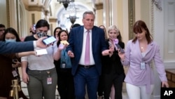 FILE - House Republican Leader Kevin McCarthy rushes to his office with reporters in pursuit at the Capitol in Washington, May 12, 2022. 