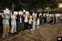 香港中文大学学生手举白纸悼念乌鲁木齐火灾死难者。（2022年11月28日）