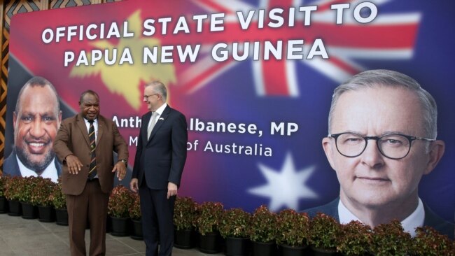 Papua New Guinea's Prime Minister James Marape (L) and his Australian counterpart Anthony Albanese pose for photos prior to their bilateral meeting in Port Moresby, Jan. 12, 2023.