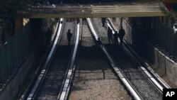 Rescue workers inspect rail lines after two subway trains collided in Mexico City, Jan. 7, 2023. 