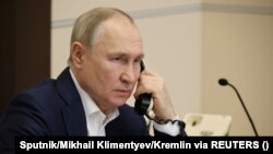 Russia's President Vladimir Putin speaks on the phone during a conversation with Agatha Bylkova from the Kurgan region, an 8-year-old participant of a New Year's and Christmas charity event, in Moscow, Russia, January 3, 2023.