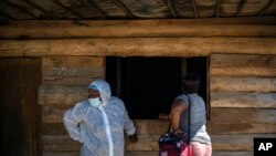 FILE - A nurse stands next to a sex worker outside a mobile HIV clinic in Ngodwana, South Africa, Thursday, July 2, 2020.