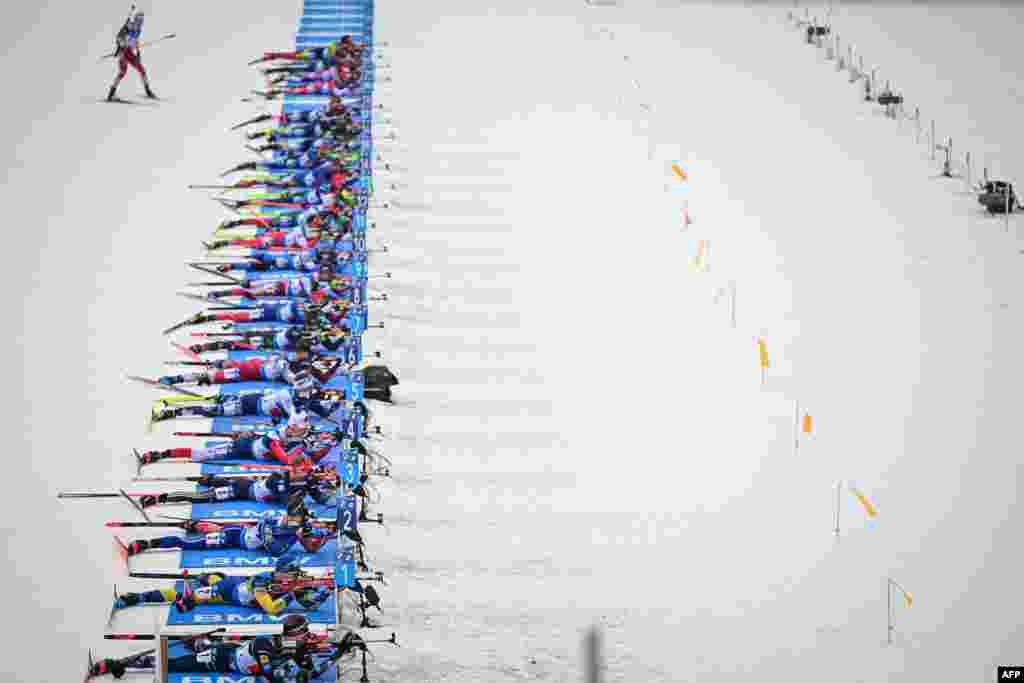 Biathletes compete at the shooting range during the 4x7,5 km Mixed Relay competition of the IBU Biathlon World Cup in Pokljuka, Slovania.